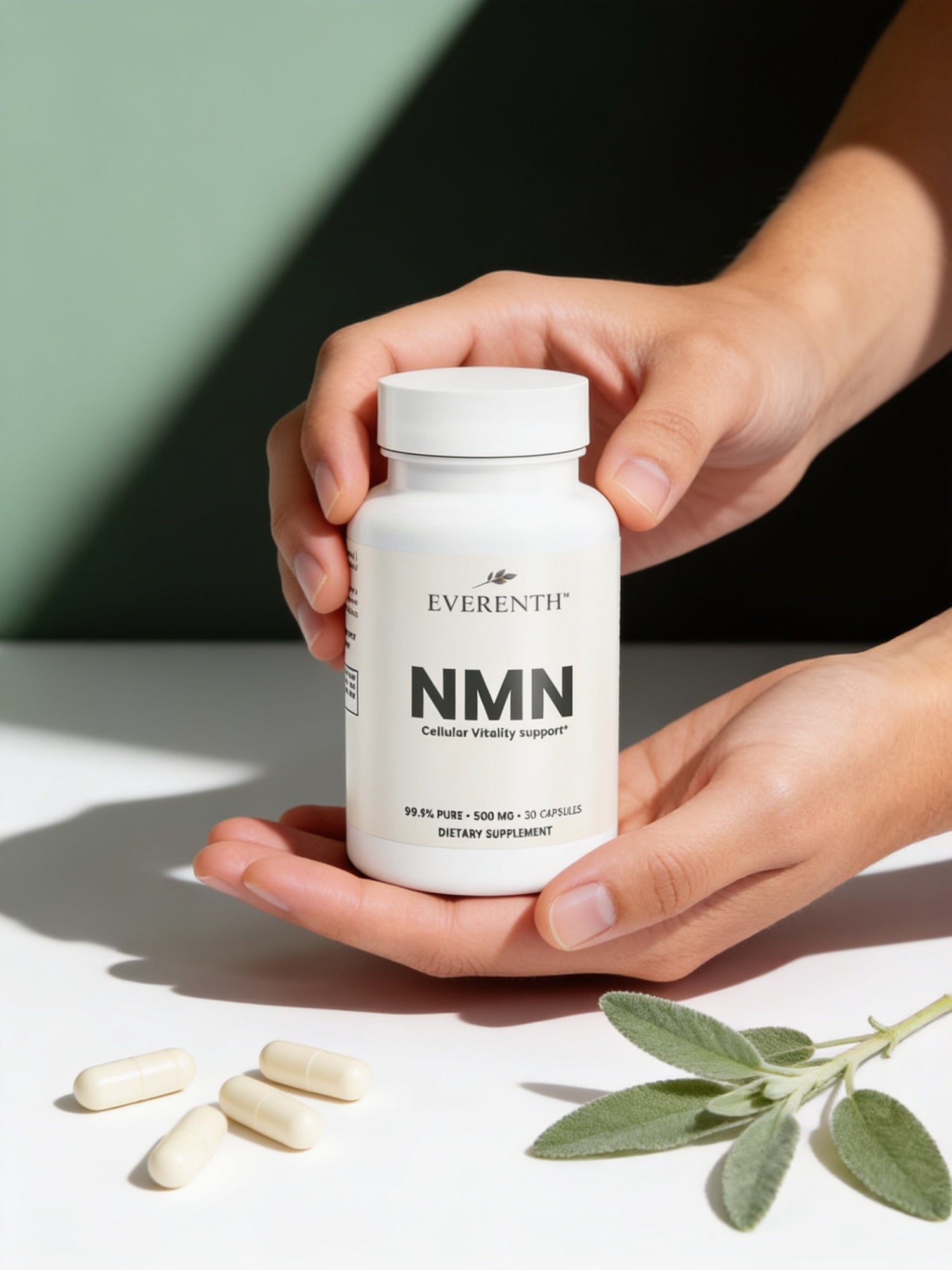 Hands holding an Everenth NMN bottle with capsules and fresh sage